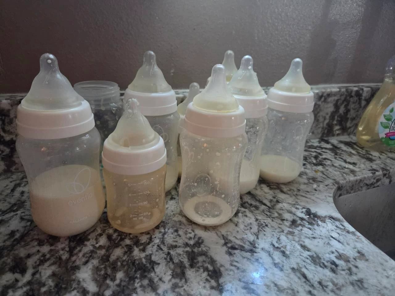 Our used bottles with leftover milk and residue waiting beside the kitchen sink