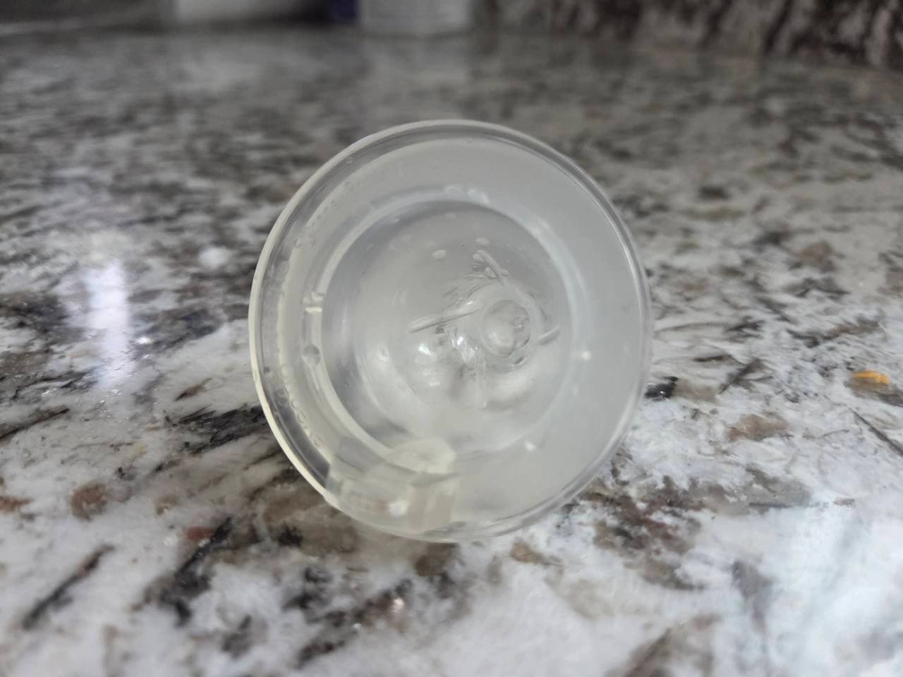 Second underside view of our translucent bottle nipple showing the molded rim markings from a lower angle