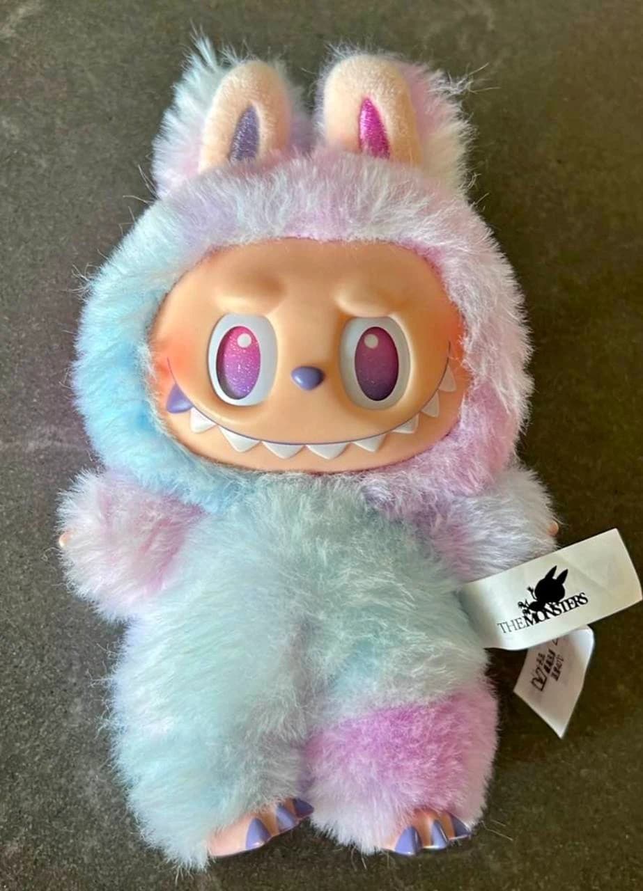 Labubu plush with blue, pink and purple fur, purple eyes and a white The Monsters tag