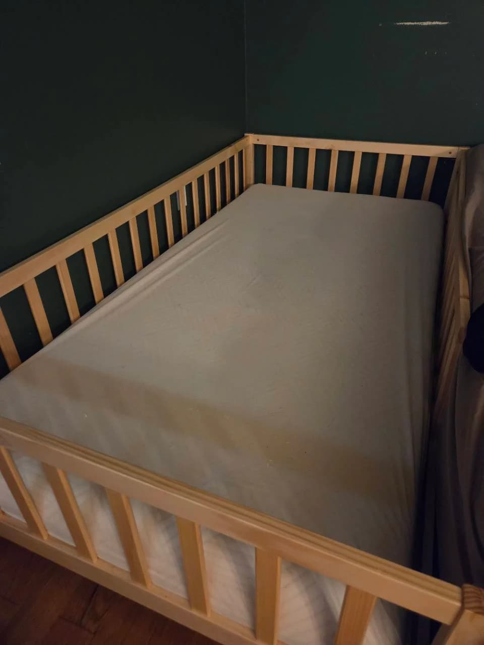 Our 6-inch FATHOM Twin mattress fitted inside a natural wood Montessori floor bed