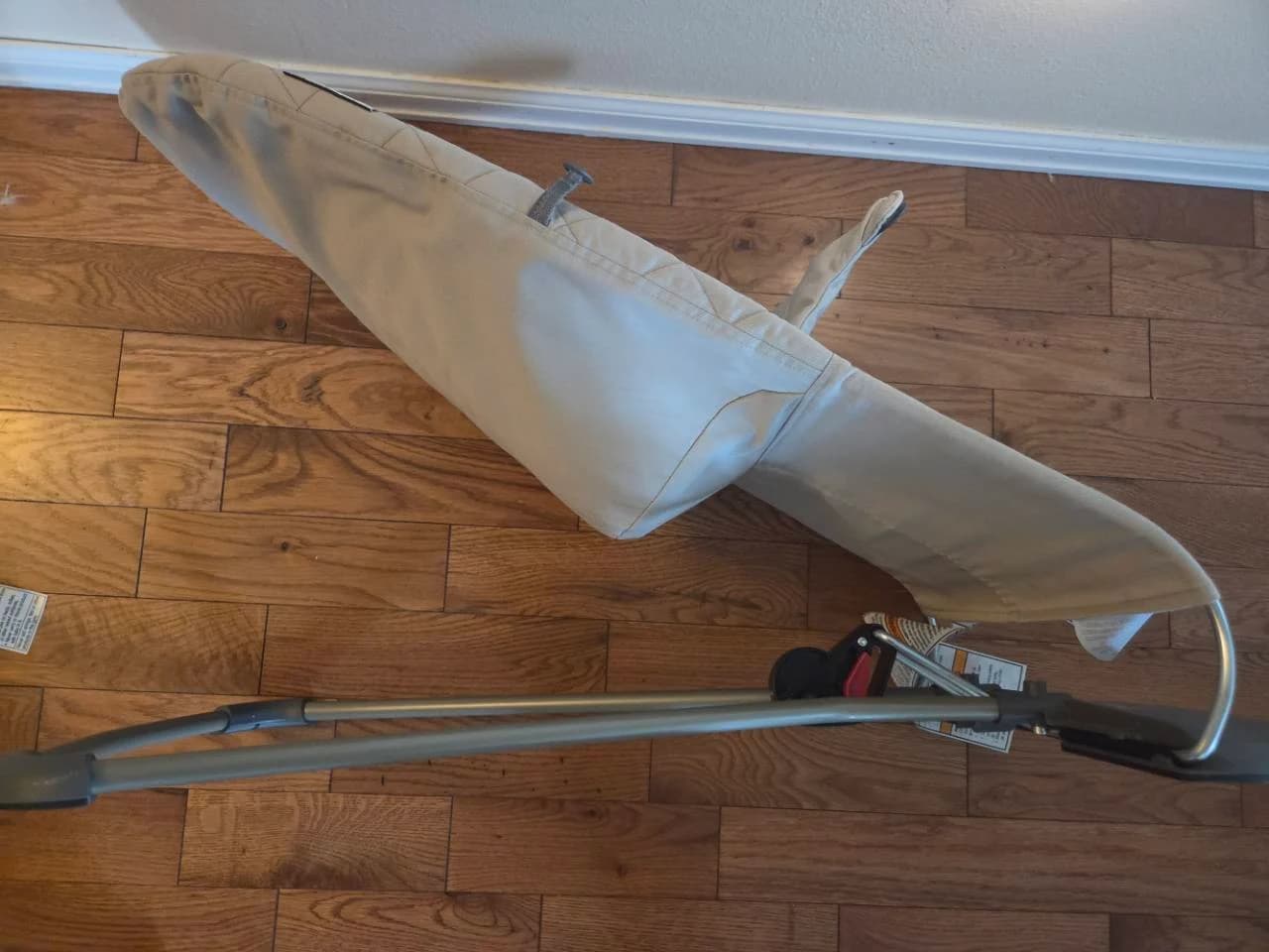 Side view of our empty BabyBjörn bouncer showing its fabric seat, long gray frame and black base