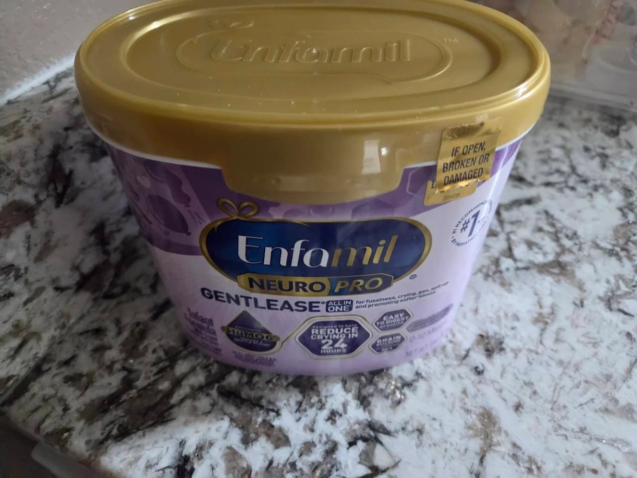 Our Enfamil NeuroPro Gentlease infant formula tub with a gold lid on the kitchen counter