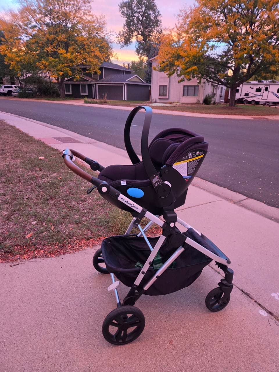 Our Clek infant car seat attached to our Mockingbird stroller on a sidewalk